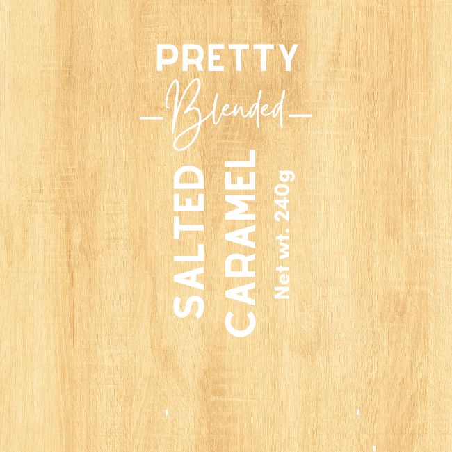 Wooden surface with 'Pretty Blended' salted caramel candle product label.
