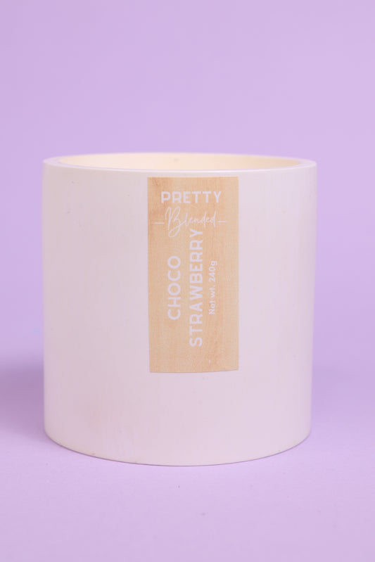 White soy candle with a 'Choco Strawberry' label on a purple background