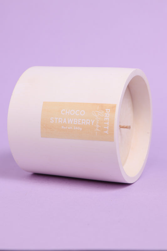 White soy candle with a label on a purple background